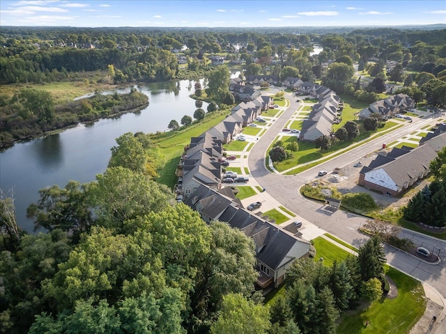 drone / aerial view featuring a residential view, a water view, and a forest view