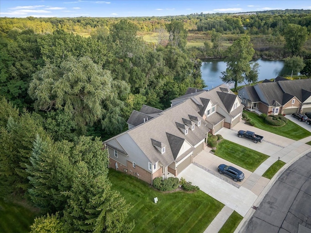 drone / aerial view featuring a forest view and a water view