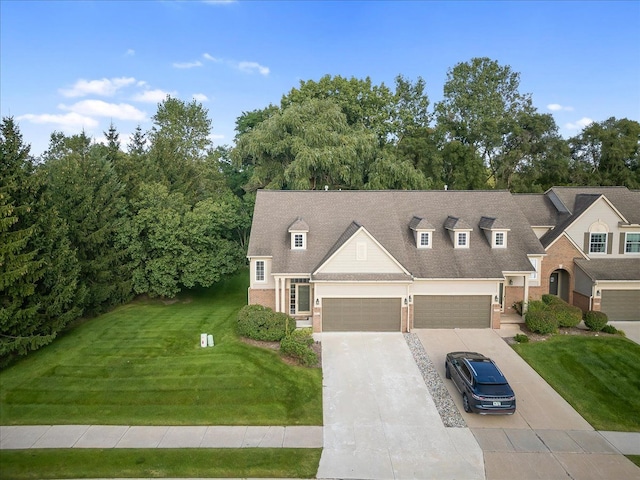 view of front of property featuring driveway, brick siding, a shingled roof, and a front yard