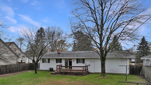 rear view of house with central AC, a yard, and a deck