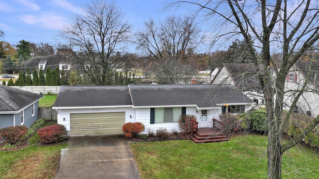 single story home featuring a front yard and a garage