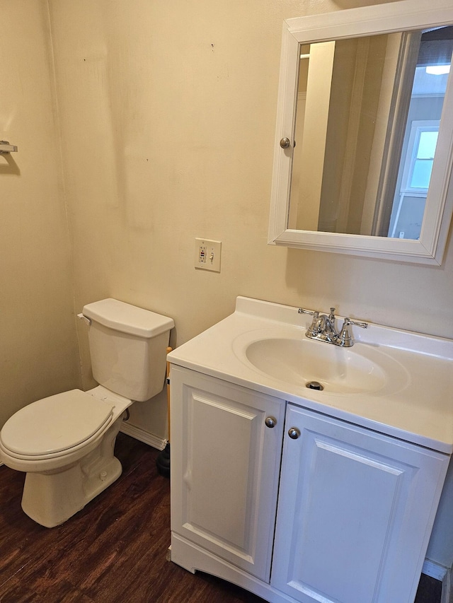 bathroom featuring hardwood / wood-style flooring, vanity, and toilet