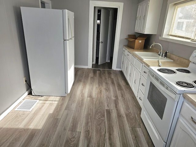 kitchen featuring white cabinetry, white appliances, sink, and light wood-type flooring