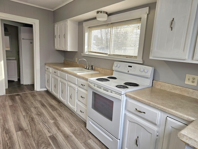 kitchen with white cabinetry, sink, hardwood / wood-style flooring, and white range with electric cooktop