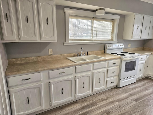 kitchen featuring white cabinetry, white electric stove, light hardwood / wood-style floors, and sink