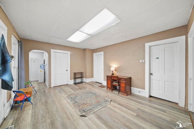 entryway with a paneled ceiling and light hardwood / wood-style floors