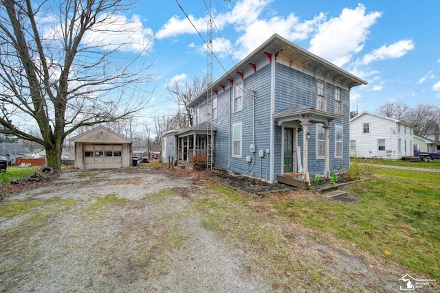 view of side of property featuring a garage, an outdoor structure, and a yard