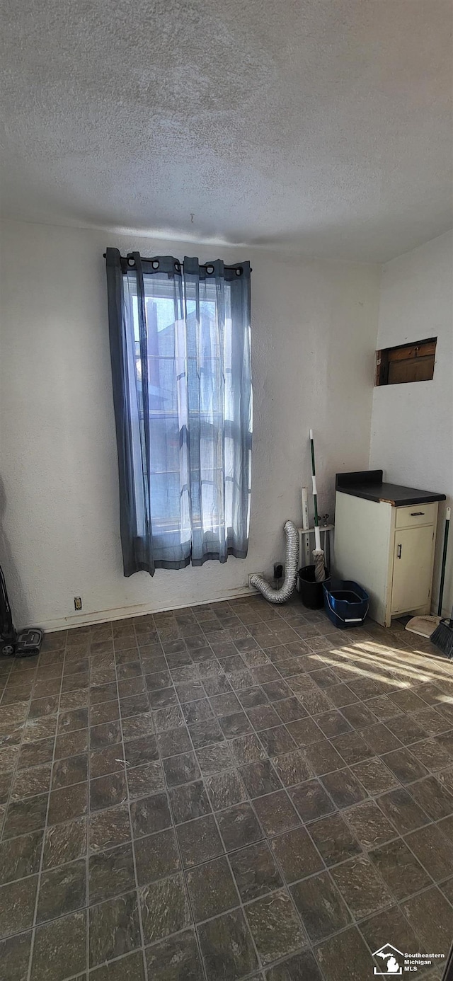 spare room with a textured ceiling