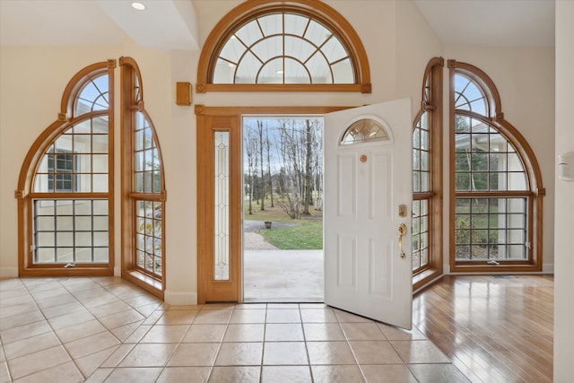 tiled foyer with a high ceiling