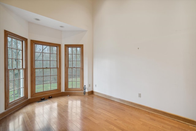 unfurnished room with light wood-type flooring