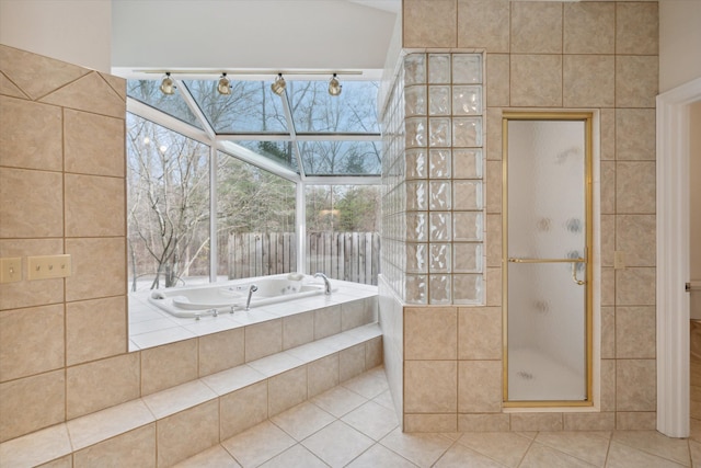 bathroom with tile patterned floors and shower with separate bathtub