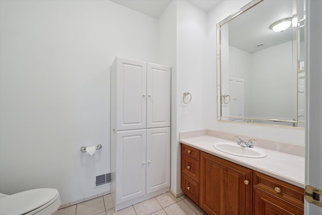 bathroom featuring toilet, vanity, and tile patterned floors