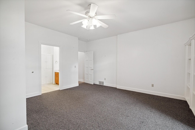 carpeted empty room featuring ceiling fan