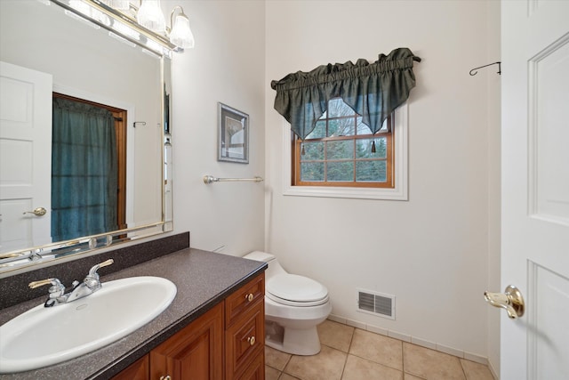 bathroom featuring tile patterned floors, vanity, and toilet