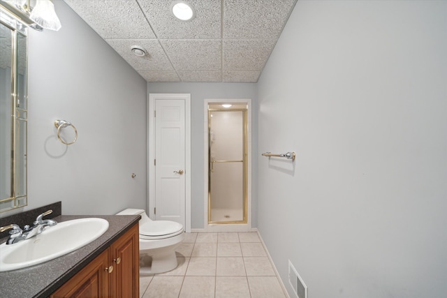 bathroom with tile patterned floors, vanity, toilet, and walk in shower