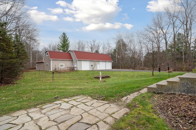 view of yard featuring an outbuilding and a garage