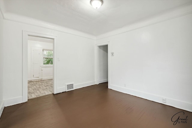 spare room featuring dark hardwood / wood-style flooring