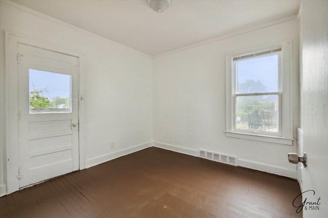 unfurnished room featuring crown molding, dark wood-type flooring, and a healthy amount of sunlight