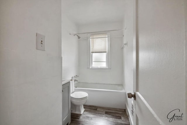 full bathroom with shower / tub combination, vanity, hardwood / wood-style flooring, and toilet