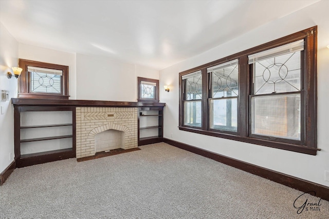 unfurnished living room featuring carpet and a fireplace