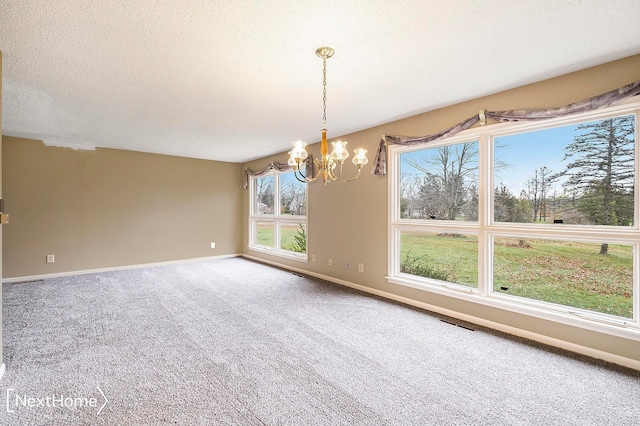 interior space featuring carpet flooring, a textured ceiling, and an inviting chandelier