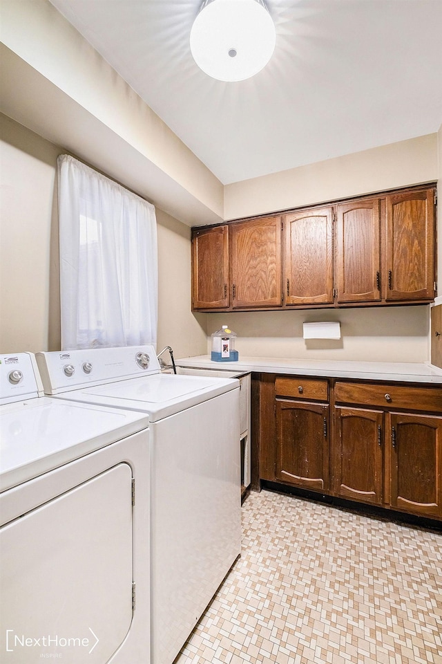 laundry room with cabinets and separate washer and dryer