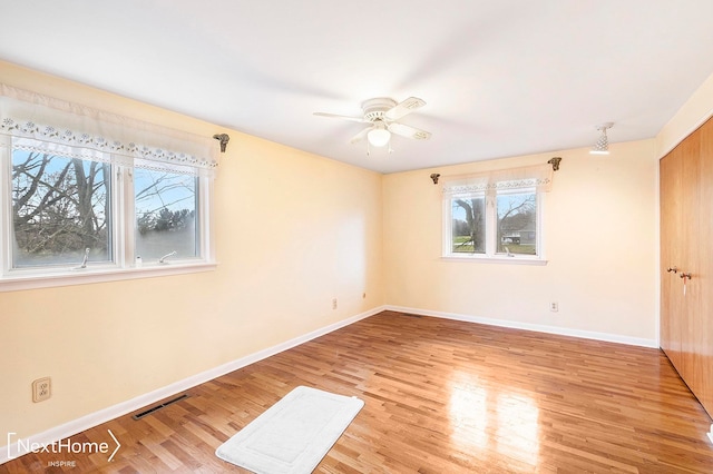 unfurnished room featuring light hardwood / wood-style floors and ceiling fan