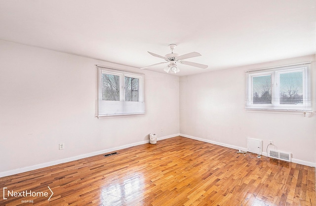 empty room with light hardwood / wood-style floors and ceiling fan