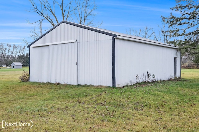 view of outbuilding featuring a lawn