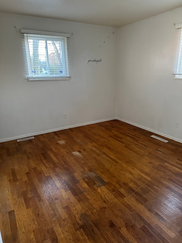 unfurnished room featuring dark wood-type flooring