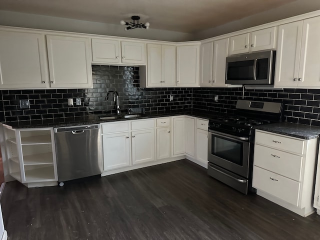 kitchen with sink, dark wood-type flooring, tasteful backsplash, white cabinets, and appliances with stainless steel finishes