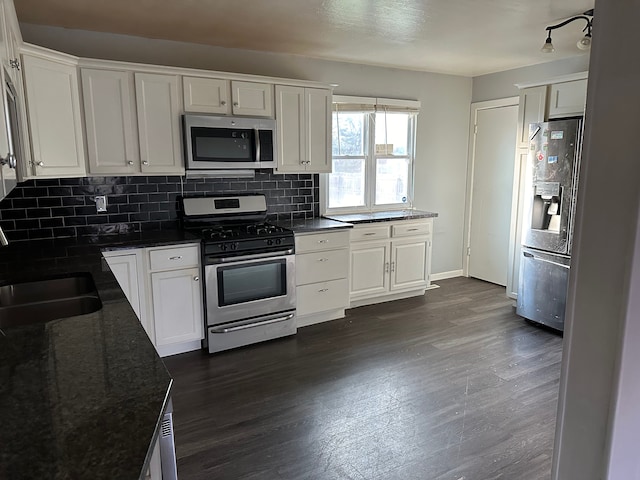 kitchen featuring white cabinets, sink, appliances with stainless steel finishes, tasteful backsplash, and dark hardwood / wood-style flooring