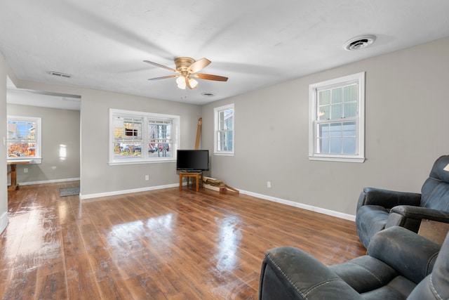 living room with hardwood / wood-style flooring, plenty of natural light, and ceiling fan