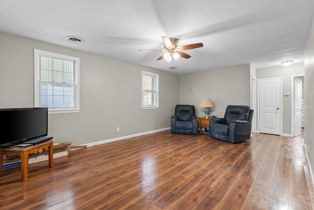 living area featuring dark hardwood / wood-style floors and ceiling fan