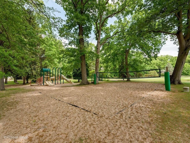 view of home's community featuring playground community and volleyball court