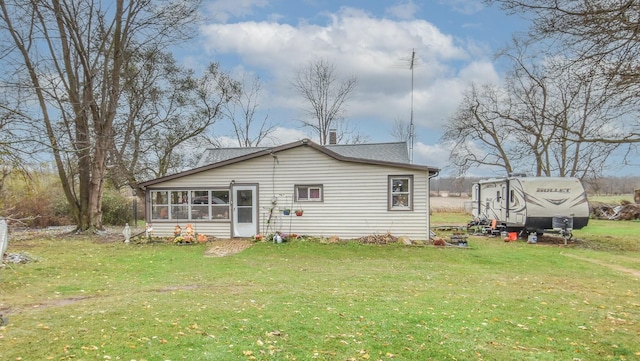 967 Newton Rd, Quincy, MI 49082 - rear view of property with a sunroom, a yard, and a shingled roof