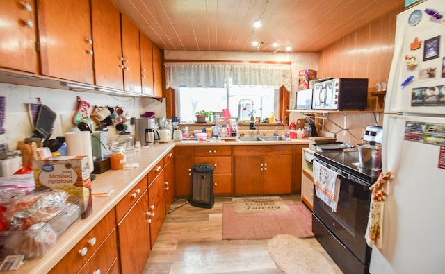 kitchen with black electric range oven, wooden ceiling, white refrigerator, sink, and light hardwood / wood-style floors