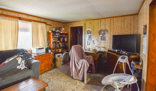 carpeted living room featuring ornamental molding and wood walls