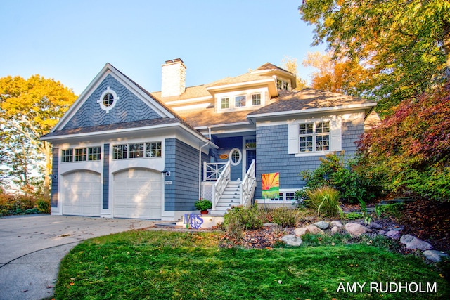 1749 Sunset Point Dr, Norton Shores, MI 49441 - shingle-style home with driveway, a garage, a chimney, stairway, and a front yard