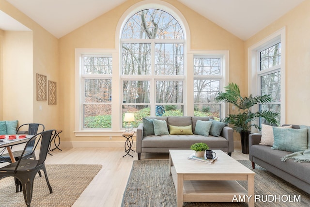 1749 Sunset Point Dr, Norton Shores, MI 49441 - living room with wood finished floors, high vaulted ceiling, and baseboards