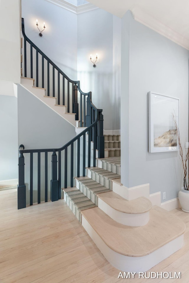 1749 Sunset Point Dr, Norton Shores, MI 49441 - staircase featuring wood finished floors, baseboards, and crown molding