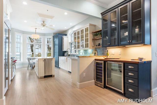 1749 Sunset Point Dr, Norton Shores, MI 49441 - bar with beverage cooler, light wood finished floors, tasteful backsplash, recessed lighting, and ornamental molding