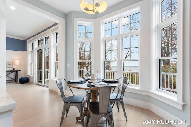 1749 Sunset Point Dr, Norton Shores, MI 49441 - dining space featuring plenty of natural light, a chandelier, wood finished floors, ornamental molding, and baseboards