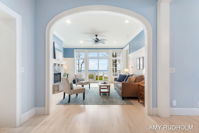 1749 Sunset Point Dr, Norton Shores, MI 49441 - living area with crown molding, arched walkways, ceiling fan, and wood finished floors