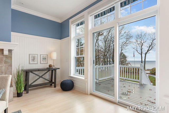 1749 Sunset Point Dr, Norton Shores, MI 49441 - doorway to outside with wood finished floors, a water view, crown molding, a decorative wall, and wainscoting