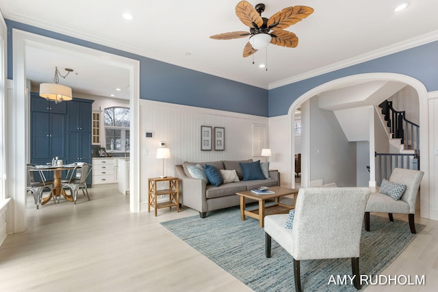1749 Sunset Point Dr, Norton Shores, MI 49441 - living room with arched walkways, light wood finished floors, a ceiling fan, stairway, and recessed lighting