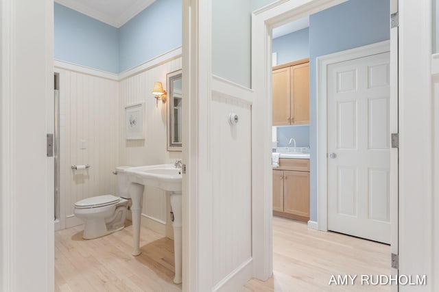 1749 Sunset Point Dr, Norton Shores, MI 49441 - full bathroom with wood finished floors, toilet, a sink, crown molding, and a shower