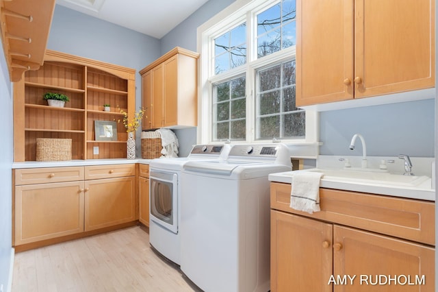 1749 Sunset Point Dr, Norton Shores, MI 49441 - laundry room featuring cabinet space, washing machine and dryer, and light wood-style floors