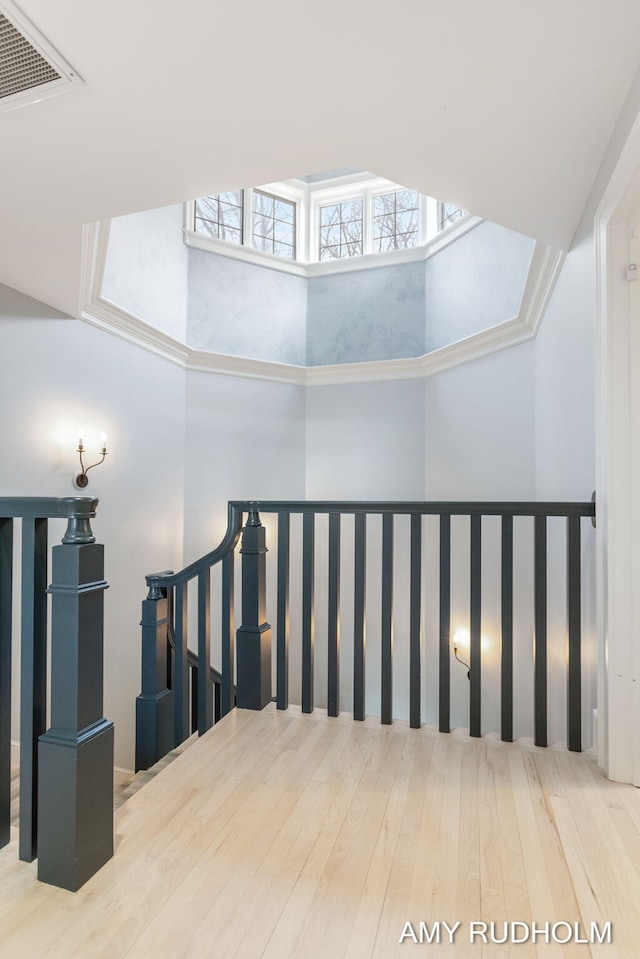 1749 Sunset Point Dr, Norton Shores, MI 49441 - stairs featuring a towering ceiling and wood finished floors