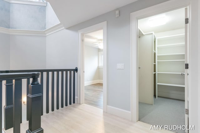 1749 Sunset Point Dr, Norton Shores, MI 49441 - hall featuring an upstairs landing, wood finished floors, and baseboards